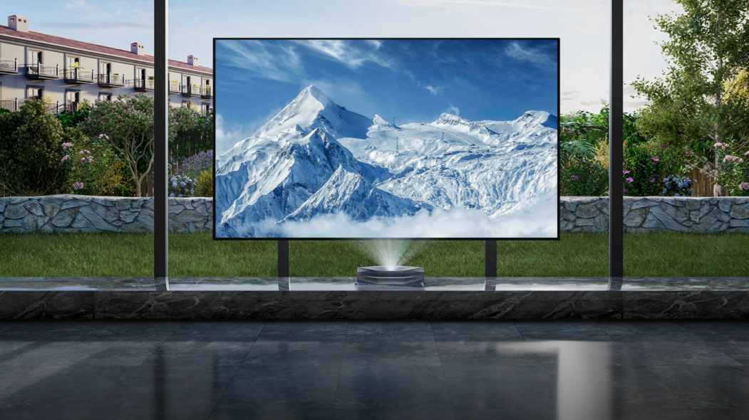 Bright mountain projection on a large screen in a sunlit modern living room.